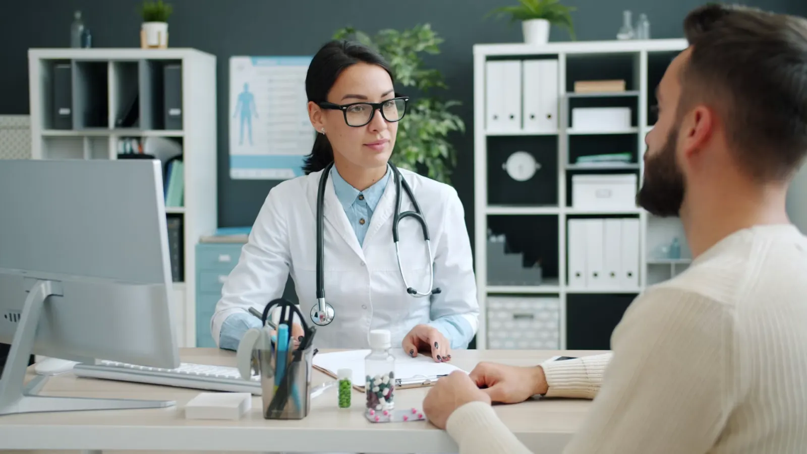 A locum physician in a white coat in a hospital setting